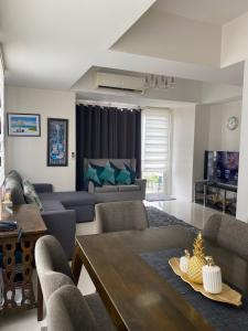 a living room with a table and a couch at Calyx Residences High End 1 Bedroom Unit in Cebu City