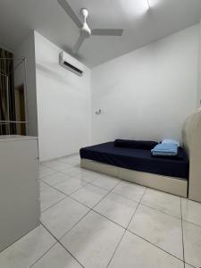 a bedroom with a bed in a white room at Homestay D BBSE in Simpang Empat