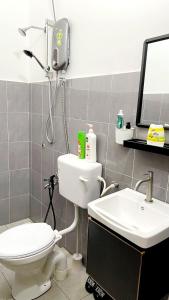 a bathroom with a toilet and a sink at Homestay THE INDRA in Kuantan +19 photos