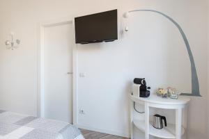 a bedroom with a bed and a tv on a wall at La Terrazza in Rho