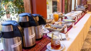 a buffet of food and drinks on a table at Hospedaje Chaska Pisac in Pisac +141 photos