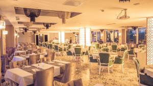 a banquet hall with white tables and chairs at Limnades Hotel İznik in İznik