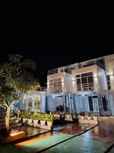 a building with plants in front of it at night at Hazuma Homestay in Tawangmangu +16 photos