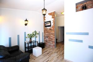 
a living room filled with furniture and a fire place at Apart Hotel Tomo FREE PARKING in Rīga
