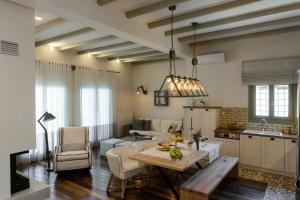 a kitchen and living room with a table and a couch at Gatzea Villas in Kato Gatzea +78 photos