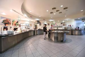 a group of people standing in a restaurant kitchen at Beit Hall in London