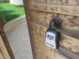 a lock on the side of a wooden door at NEAR AIRPORT 2 STOPS By METRO, STATION METRO"PEANIA-KANTZA" in Leondárion