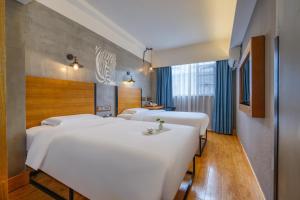 Katil atau katil-katil dalam bilik di Gongxili - Chujian Hotel