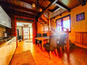 a kitchen with a table and chairs in a room at Chatka M3 in Abrahamovce