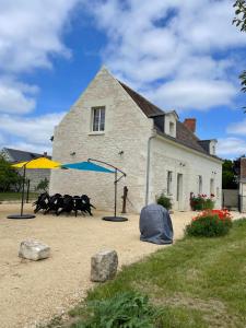 a house with a playground in front of it at Fermette Tourangelle in Bréhémont