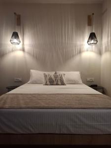 a bedroom with a bed with two pillows on it at Hotel Platon in Faliraki