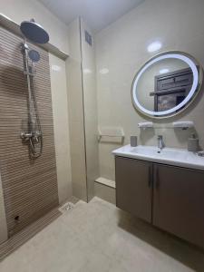 a bathroom with a sink and a mirror at Surf appartement Taghazout 4 in Taghazout
