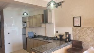 a kitchen with a counter top and a stove top oven at Surf appartement Taghazout 4 in Taghazout