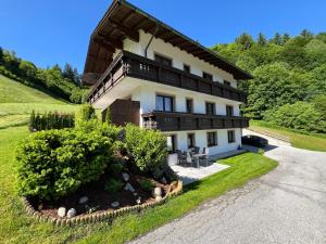 a house with a balcony on a hill at Appartement Maria Theresia in Hopfgarten im Brixental