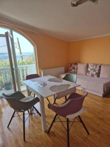 a living room with a table and chairs and a couch at Apartments Veni Up in Starigrad-Paklenica +134 photos