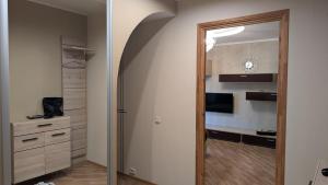 a hallway leading to a kitchen with a door to a room at Celtnieku 8 in Ventspils