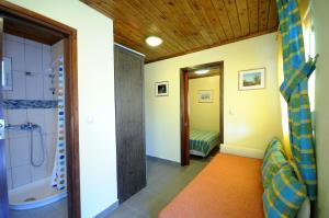 a bathroom with a shower and a sink and a tub at Haus Platanos Apartments & Bungalows by the Sea in Vourvourou