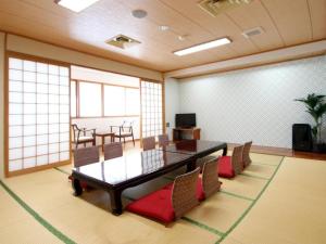 a conference room with a table and chairs in a room at Hotel Livemax BUDGET Chitose in Sapporo