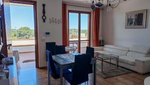 a living room with a couch and a table and chairs at Vacanze in villa in Nardò