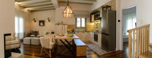 a kitchen with a table and a refrigerator at Gatzea Villas in Kato Gatzea