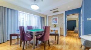a dining room with a table and some purple chairs at Zhuzhou Jinjin Haiyue Hotel in Zhuzhou
