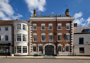 a large red brick building with a front door at The George Townhouse in Shipston-on-Stour
