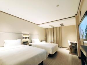 Hanting Hotel Shenzhen Baoan Xixiang Taoyuanju客房内的一张或多张床位