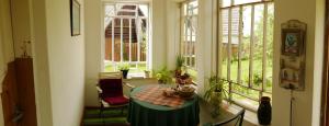 a dining room with a table and a window at Namelis 1954 in Švenčionėliai