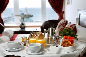 a table with breakfast foods and orange juice at Park Central Hotel in Bournemouth