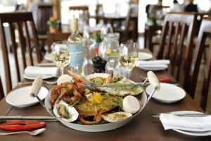 a plate of food on a table with wine glasses at Park Central Hotel in Bournemouth