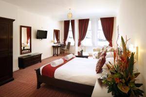 a hotel room with a large bed and a large window at Park Central Hotel in Bournemouth