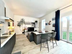 a kitchen and living room with a table and chairs at Como lake stay& service in Como
