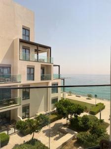 an apartment building with a view of the ocean at Address Beach Resort Fujairah Apartment by Blue World - 3 in Fujairah