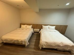 Posteľ alebo postele v izbe v ubytovaní Xingyi Hotel