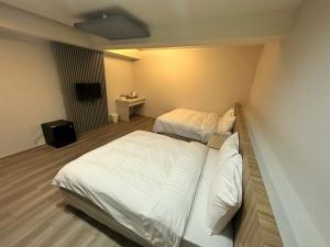 Posteľ alebo postele v izbe v ubytovaní Xingyi Hotel
