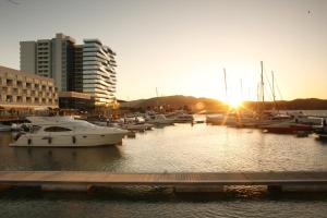 a group of boats docked in a marina at sunset at Troia Design Hotel in Troia