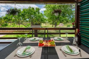 a table with a tray of fruit on a balcony at Apartment Martin-nearby Krka National park in Kaočine