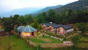 an aerial view of a house on a hill at Camp Kelang a Mountain View Camping Bonfire near Paragliding landing site in Bīr