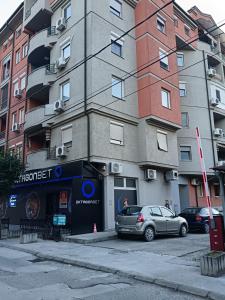 a building with a car parked in front of it at Studio City day in Jagodina