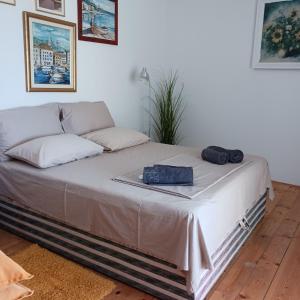 a bed with two bags sitting on top of it at Apartments Elena & Damir in Vis