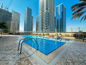 a swimming pool in a city with tall buildings at What a view - very close to DMCC metro station in Dubai