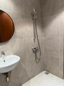 a bathroom with a shower and a sink at Pollux Habibie Deluxe Sea View By Superstay in Batam Center