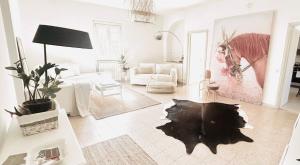 a white living room with a couch and a table at Casa a Tuscania - Borgo Stays in Tuscania