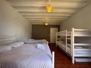 a bedroom with two bunk beds and a chandelier at L'endurance 24 in Teloché