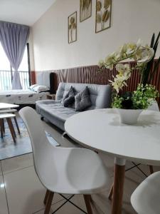 a living room with a white table and a couch at Alinea Suites Shah Alam Seksyen 14 in Shah Alam