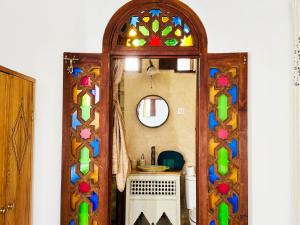 a room with a doorway with a stained glass window at Charming Riad Medina View 4 AC Bedrooms Panoramic Terrace Central Fez in Fès al Bali