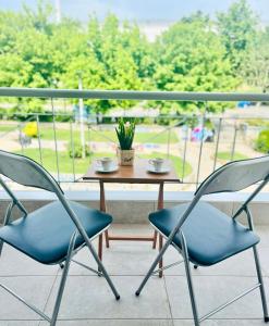two chairs and a table on a balcony at Thess City House with Parking in Thessaloniki