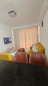 a living room with two beds and a tv at Padmore Residences - B1506 in Nairobi
