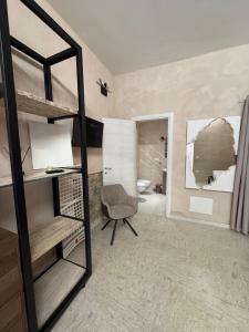 a bedroom with a bunk bed with a chair and a mirror at Case Vacanze Sant'Agostino in Pizzo