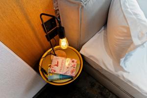 a table with a book on it next to a bed at MM Boutique Hotel in Burgas